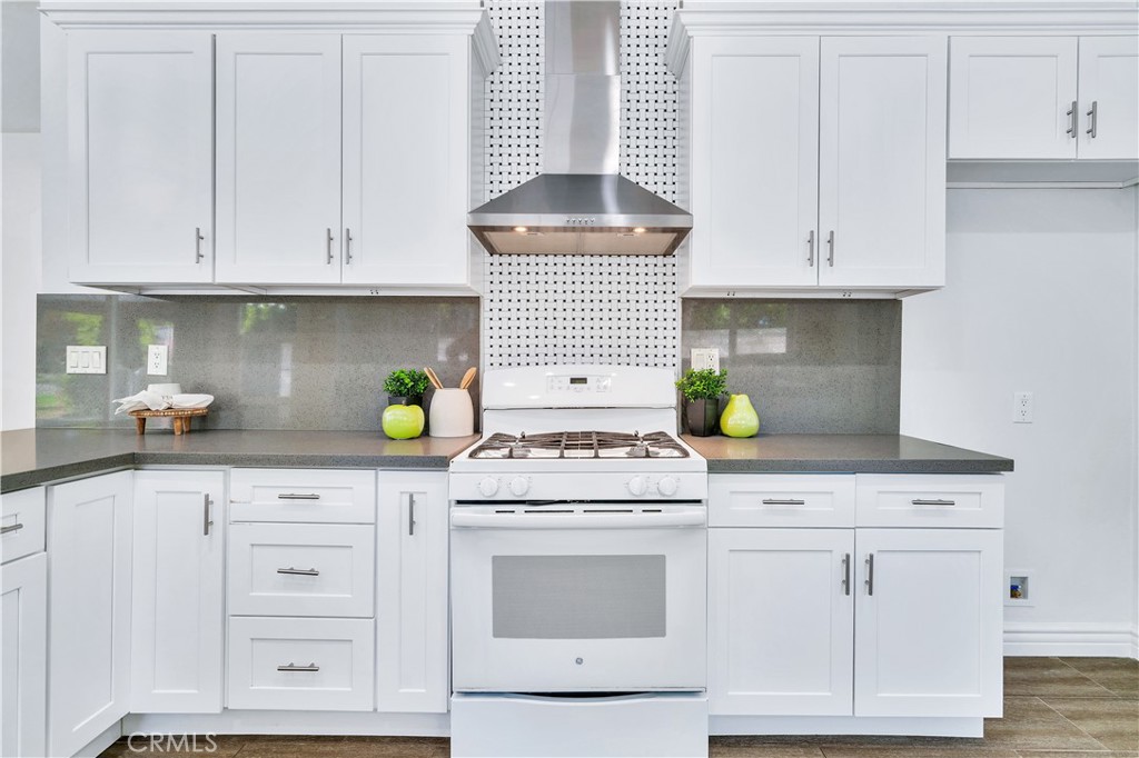 511-unit 1 Alvarado Street Redlands, CA 92373 - Photo 27 of 56 a kitchen with granite countertop white cabinets and white appliances