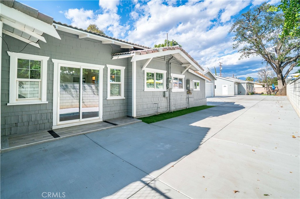 511-unit 1 Alvarado Street Redlands, CA 92373 - Photo 35 of 56 a view of a white house with a yard and large tree