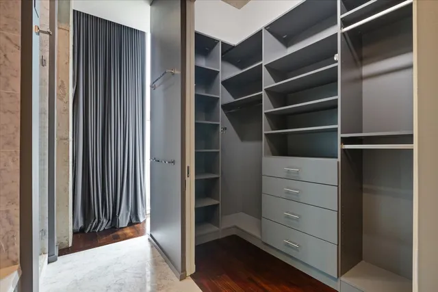 a view of walk in closet with empty racks