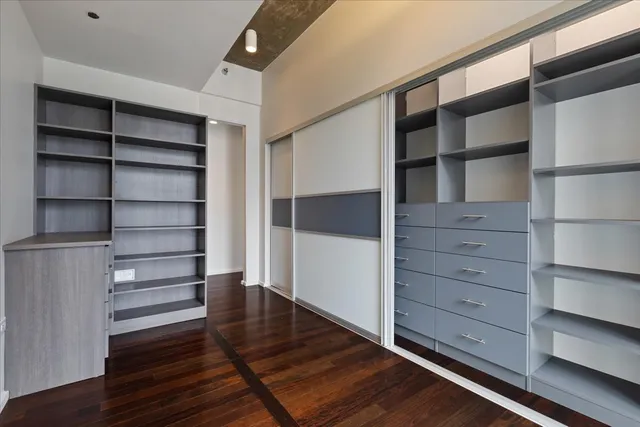 a view of walk in closet with empty racks