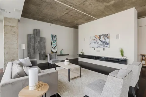 a living room with furniture and a wall painting