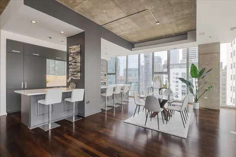 a living room with furniture a wooden floor and a large window