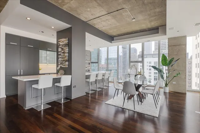 a living room with furniture a wooden floor and a large window