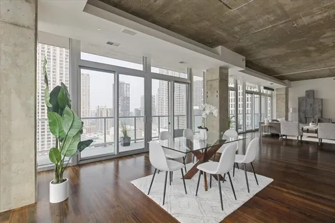 a view of a dining room with furniture window and wooden floor