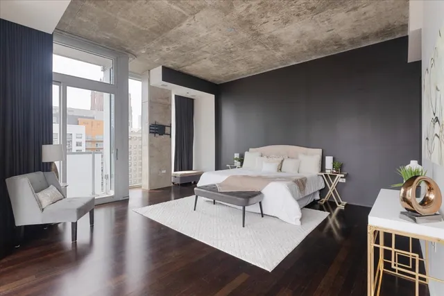 a living room with furniture a table and wooden floor