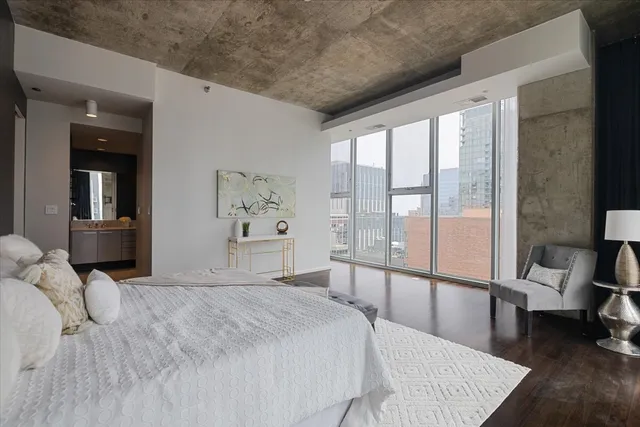 a bedroom with a large bed and a large window