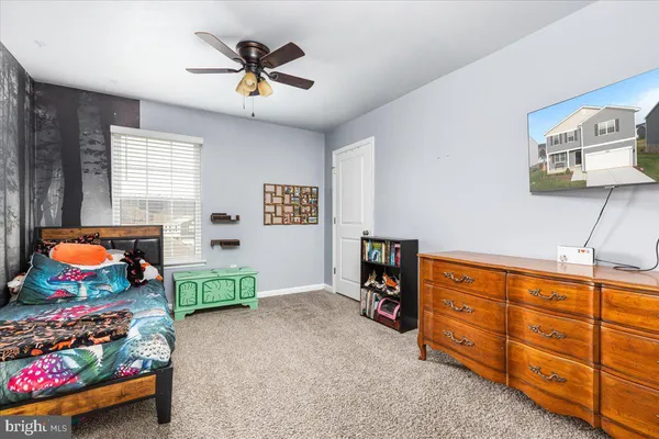 a bedroom with furniture and a window