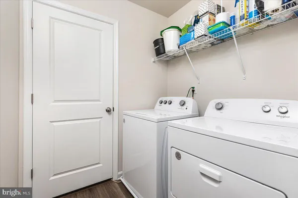 a view of storage and utility room with washer and dryer
