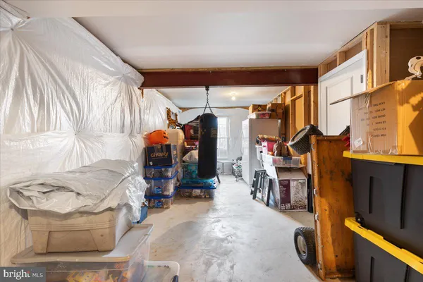 a view of living room with furniture and clothes