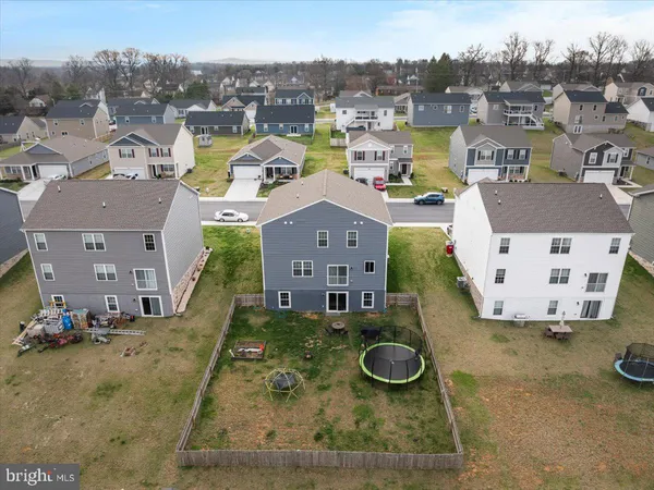 an aerial view of a house with yard