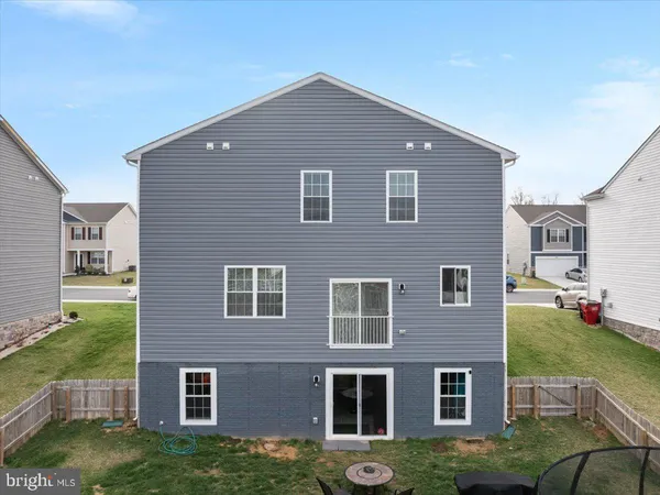a aerial view of a house next to a big yard