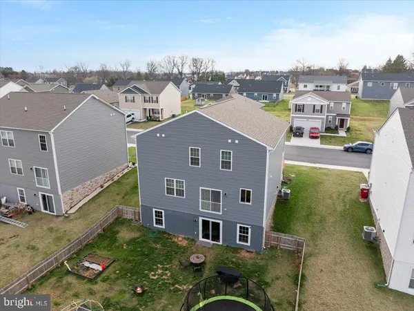 an aerial view of residential houses with outdoor space and parking