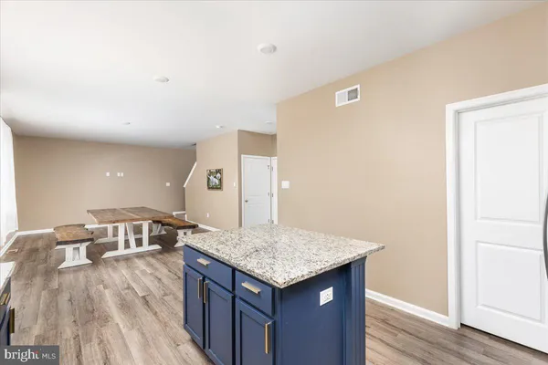 a kitchen with granite countertop a stove and a sink