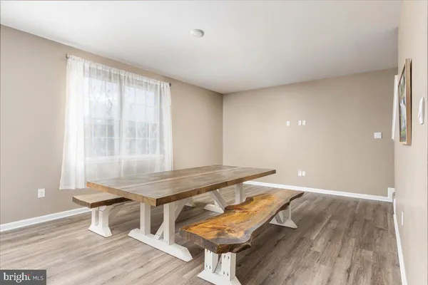 a room with wooden floor and windows