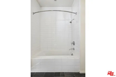 a bathroom with a shower and a bath tub