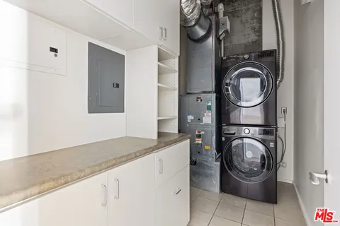 a utility room with sink dryer and washer