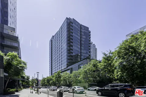 a view of a buildings and car parked on the roadside
