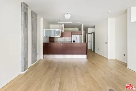 a view of kitchen and hallway with wooden floor