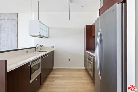a kitchen with stainless steel appliances granite countertop a refrigerator and a sink