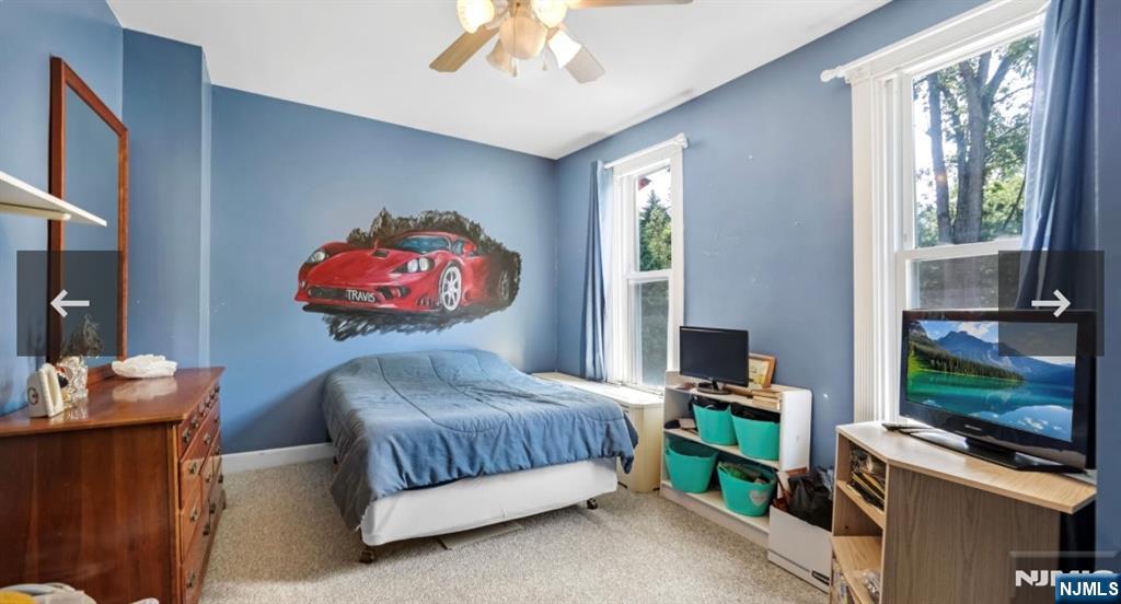 79 North 5th Street Park Ridge, NJ 07656 - Photo 7 of 11 a bedroom with a bed and a flat tv screen on dresser