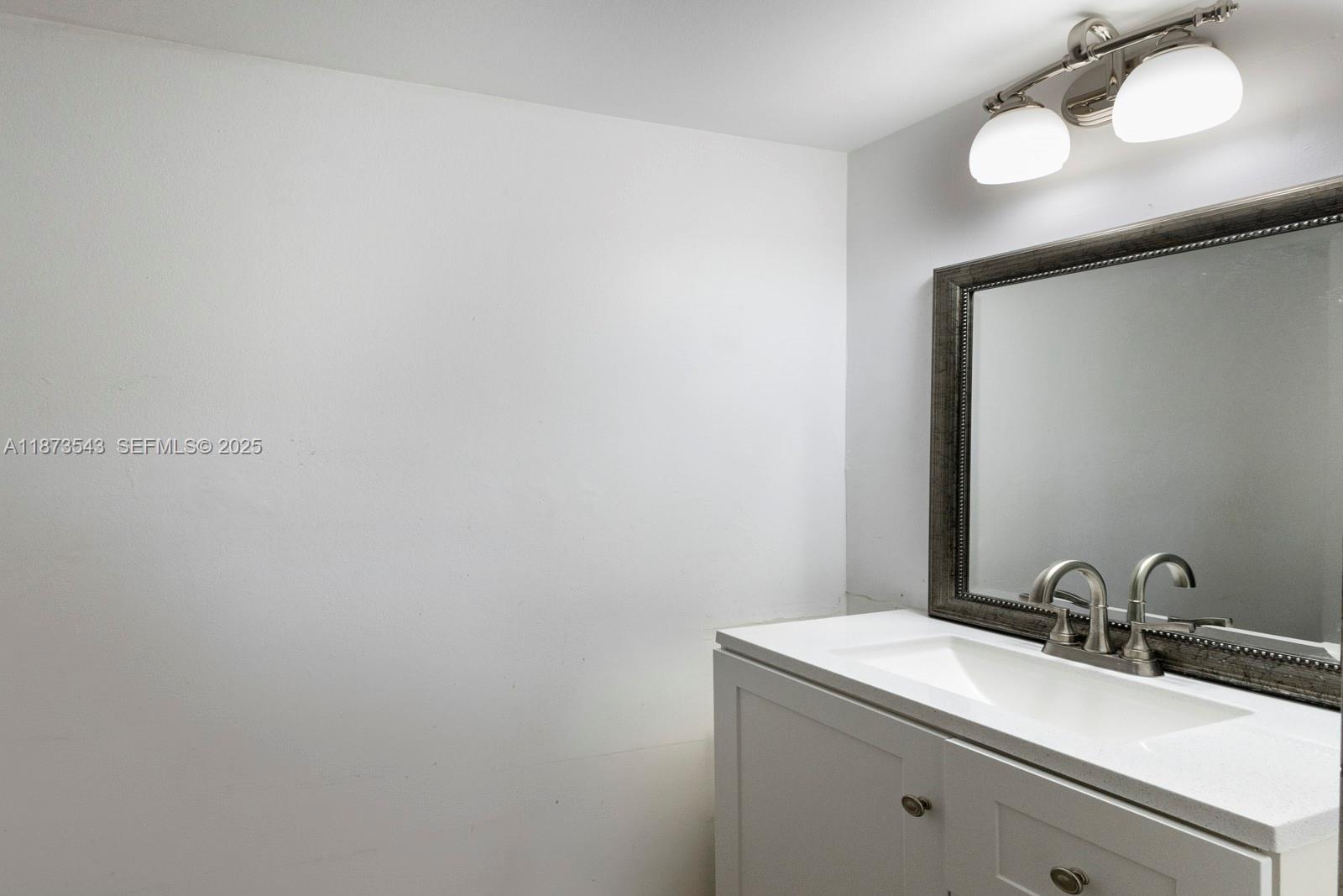 6924 Southwest 114th Place, Unit H56 Miami, FL 33173 - Photo 11 of 19 a bathroom with a sink and a mirror