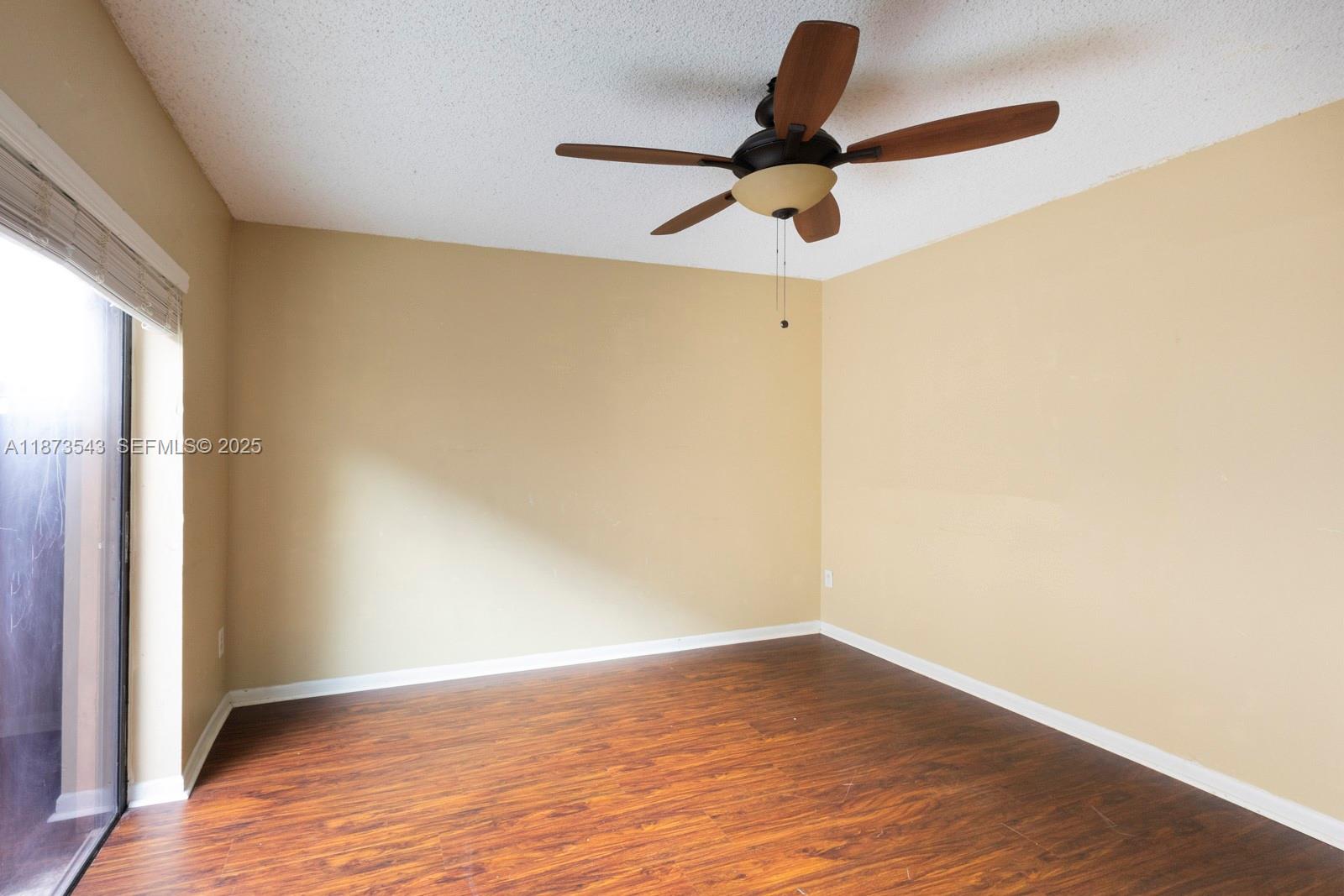 6924 Southwest 114th Place, Unit H56 Miami, FL 33173 - Photo 16 of 19 a view of empty room with wooden floor