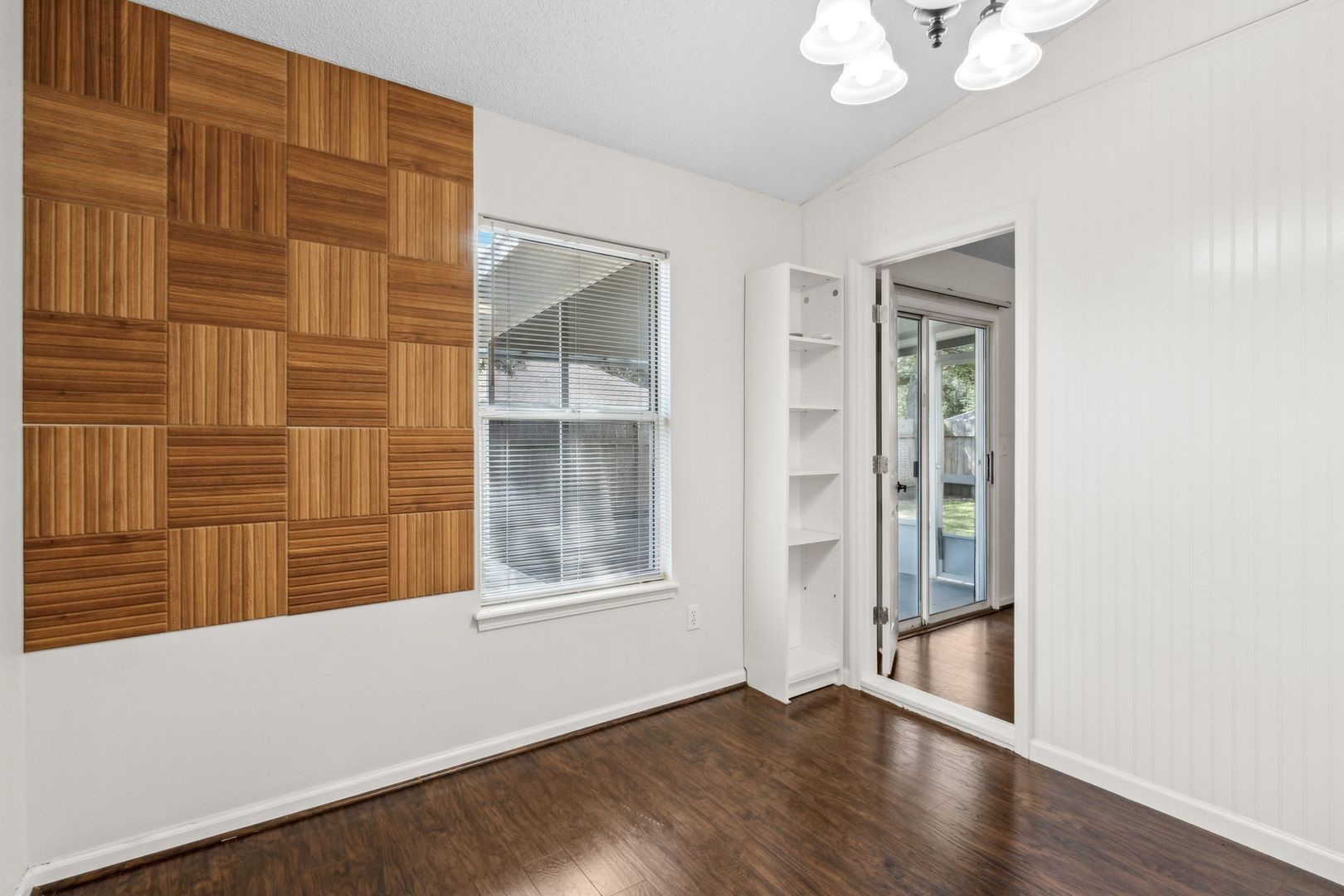 2102 Inverness Road Fernandina Beach, FL 32034 - Photo 11 of 29 a view of an empty room with a window and wooden floor