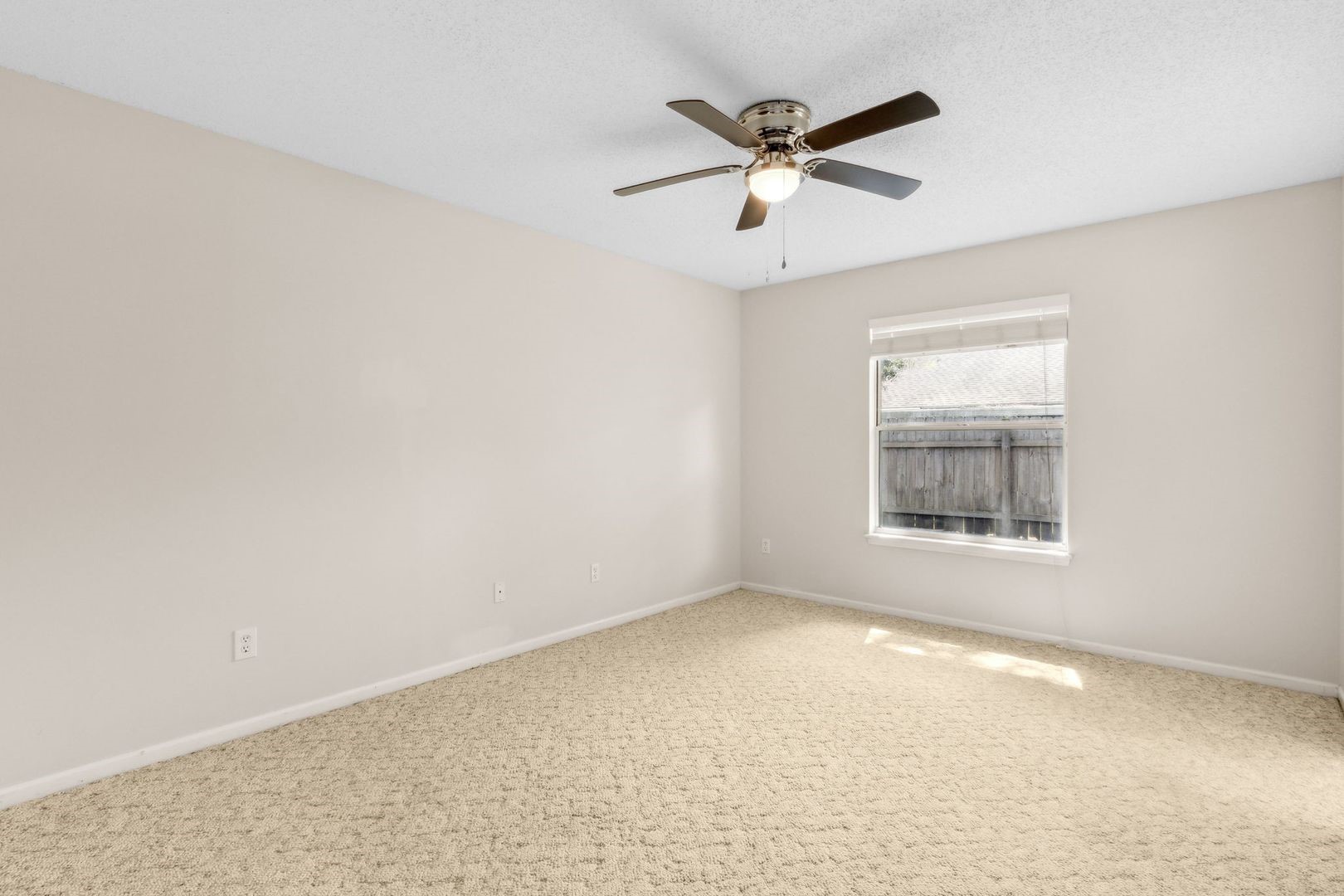2102 Inverness Road Fernandina Beach, FL 32034 - Photo 12 of 29 an empty room with a window and a fan