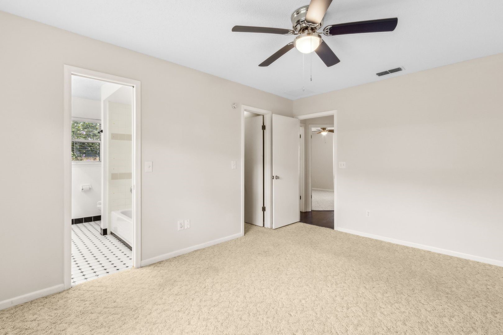 2102 Inverness Road Fernandina Beach, FL 32034 - Photo 13 of 29 an empty room with chandelier fan and windows