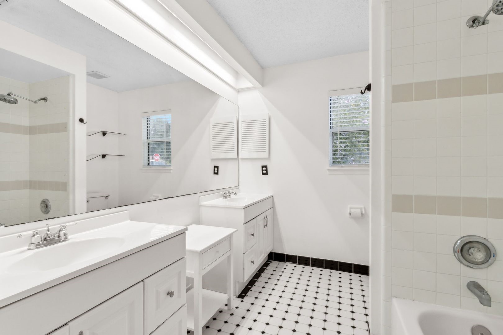 2102 Inverness Road Fernandina Beach, FL 32034 - Photo 16 of 29 a spacious bathroom with a double vanity sink a mirror and a shower