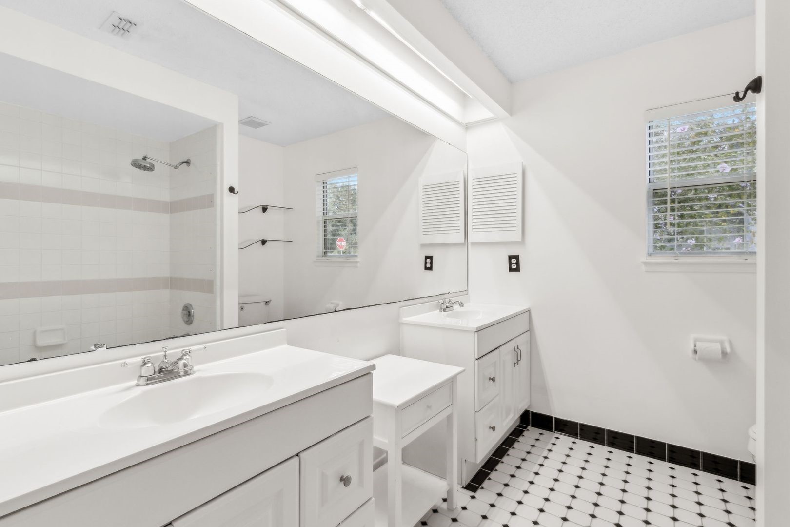 2102 Inverness Road Fernandina Beach, FL 32034 - Photo 17 of 29 a bathroom with a sink a mirror and a shower