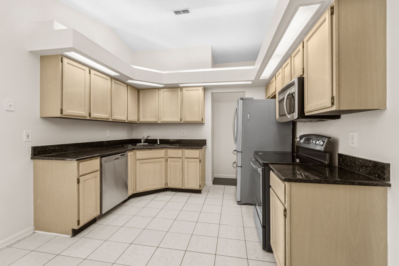 2102 Inverness Road Fernandina Beach, FL 32034 - Photo 7 of 29 a kitchen with stainless steel appliances granite countertop a stove a sink and a refrigerator