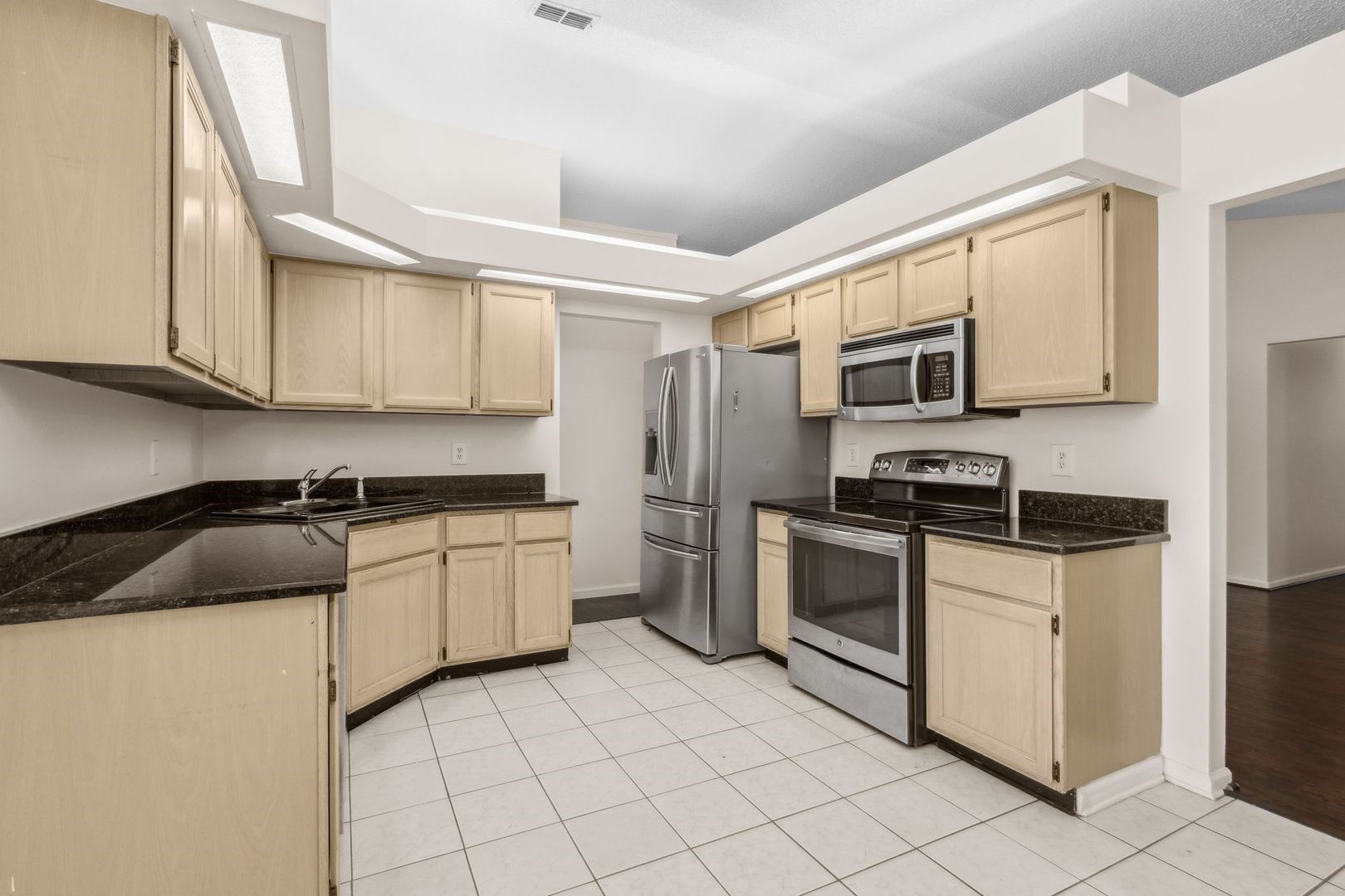 2102 Inverness Road Fernandina Beach, FL 32034 - Photo 8 of 29 a kitchen with granite countertop a sink a stove top oven and cabinetry