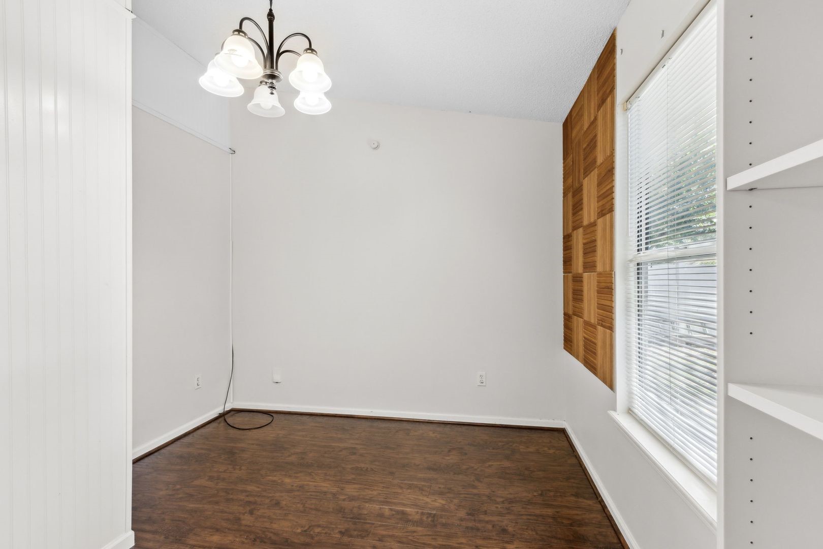 2102 Inverness Road Fernandina Beach, FL 32034 - Photo 10 of 29 an empty room with wooden floor exposed radiator and windows