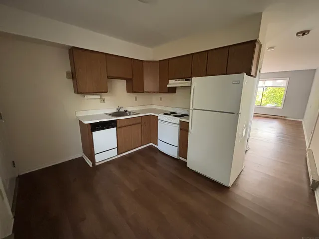 a kitchen with stainless steel appliances a refrigerator sink and cabinets