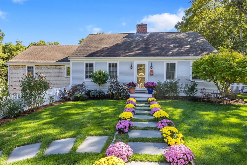 a front view of house with yard outdoor seating and green space