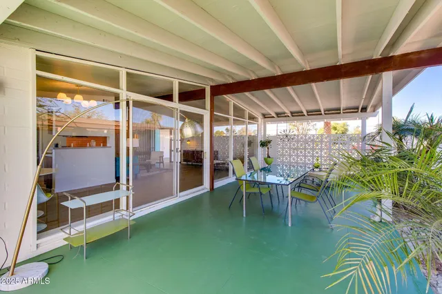a view of a chairs and table in patio