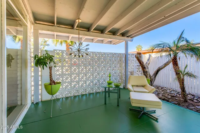 a view of a chairs and table in patio