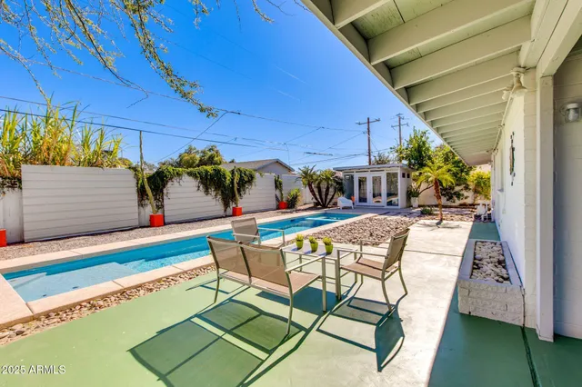 swimming pool view with a garden space