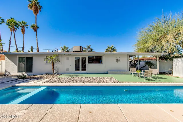 a view of a porch with a table and chairs