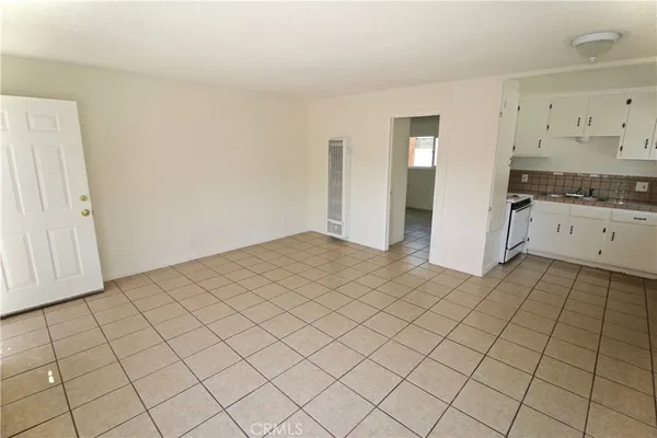 a view of a kitchen with white cabinets