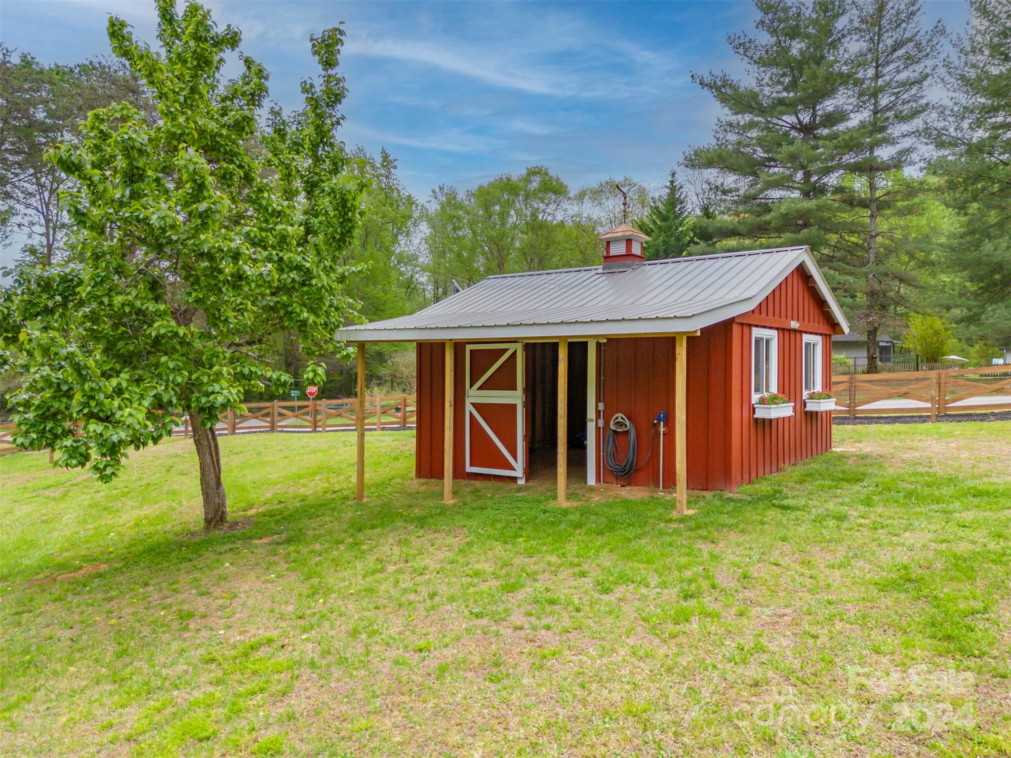 104 Red Barn Road Landrum, SC 29356 - Photo 23 of 36 a view of a house with a yard and sitting area
