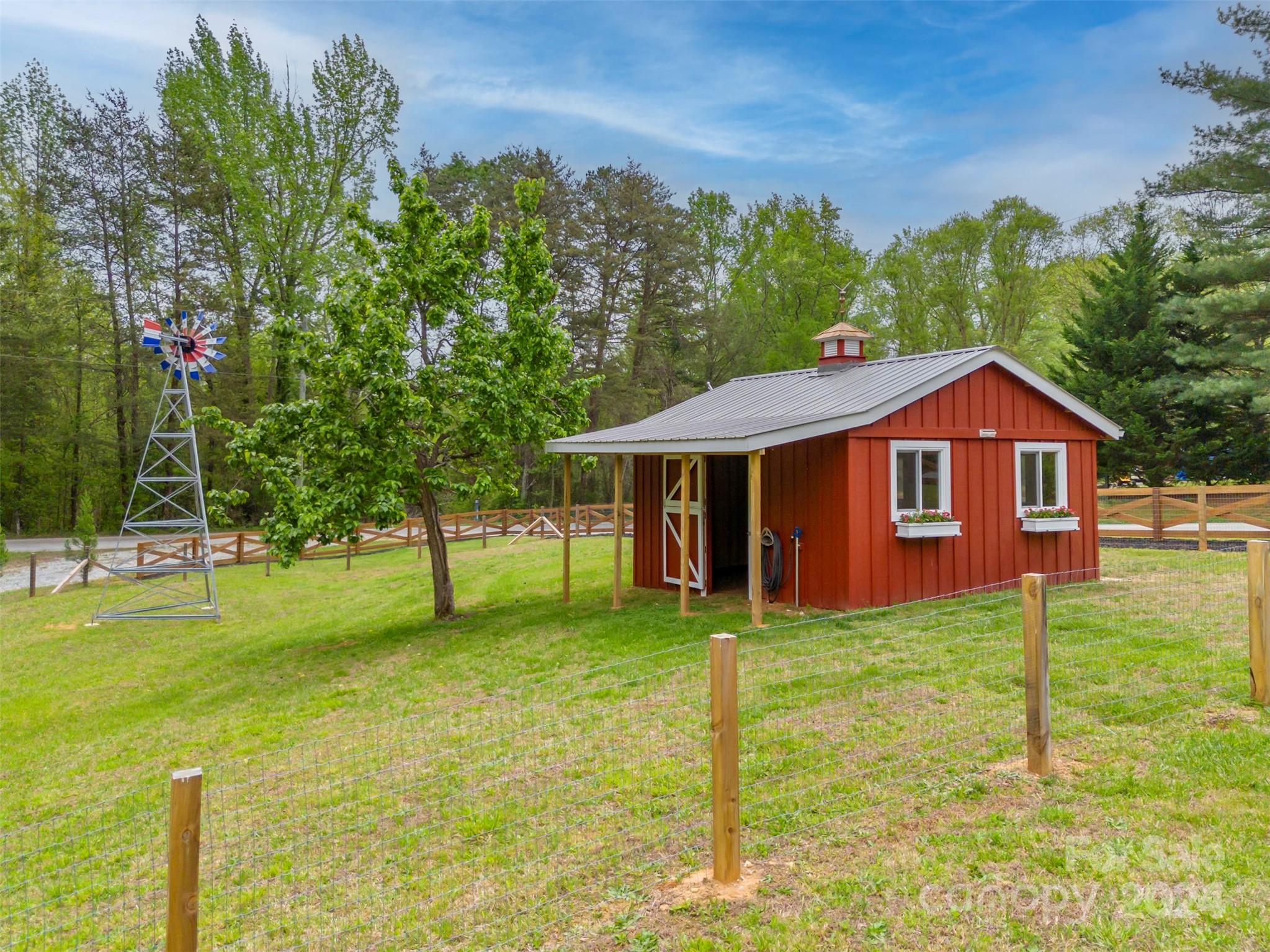 104 Red Barn Road Landrum, SC 29356 - Photo 24 of 36 a front view of a house with garden