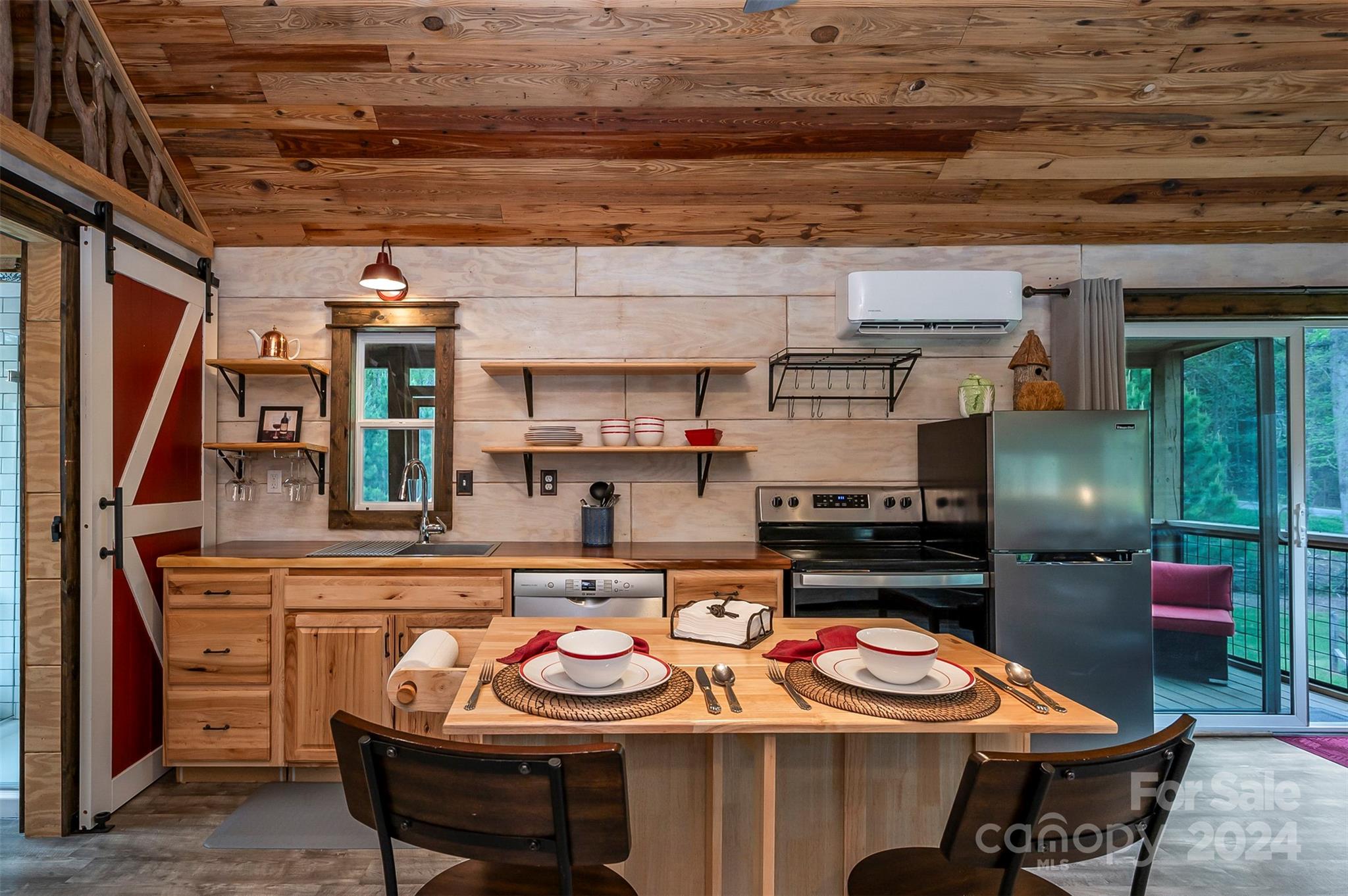 104 Red Barn Road Landrum, SC 29356 - Photo 8 of 36 a table with chairs and a stove