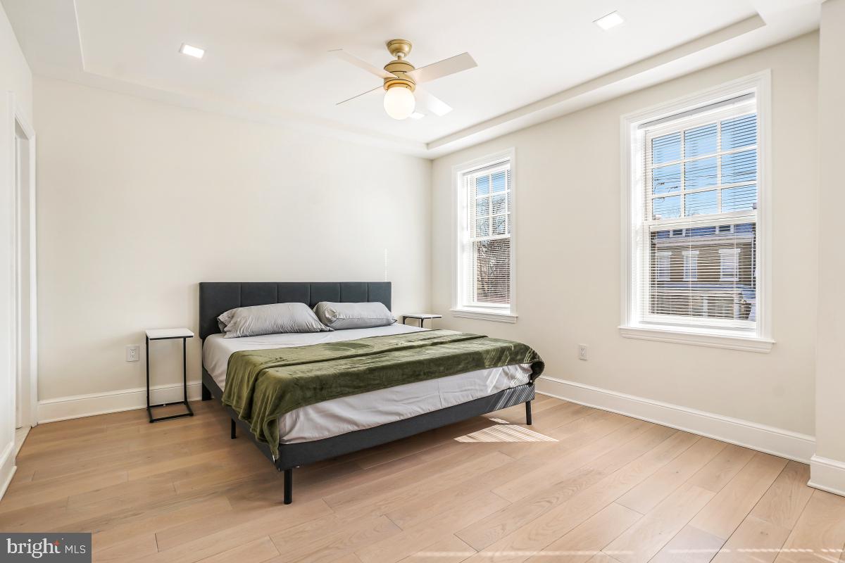 4420 15th Street Northwest Washington, DC 20011 - Photo 16 of 30 a spacious bedroom with a bed and a window