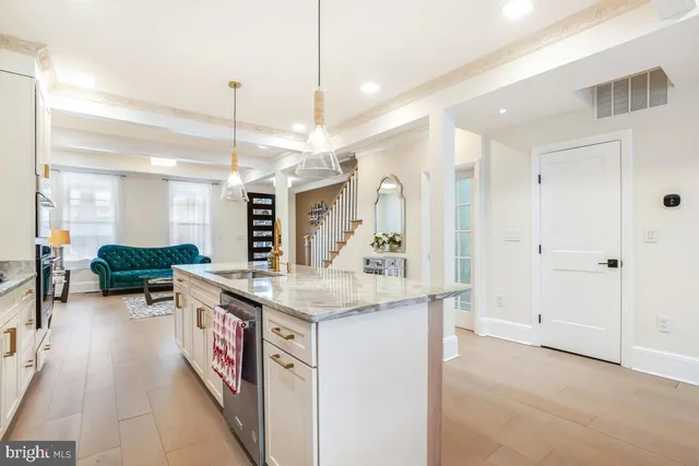 a kitchen with stainless steel appliances granite countertop a stove and a refrigerator