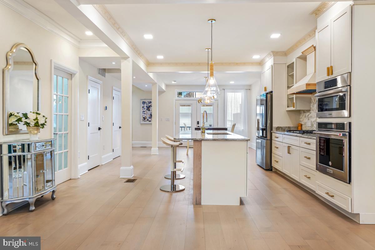 4420 15th Street Northwest Washington, DC 20011 - Photo 9 of 30 a kitchen with stainless steel appliances kitchen island granite countertop a stove a sink and a refrigerator