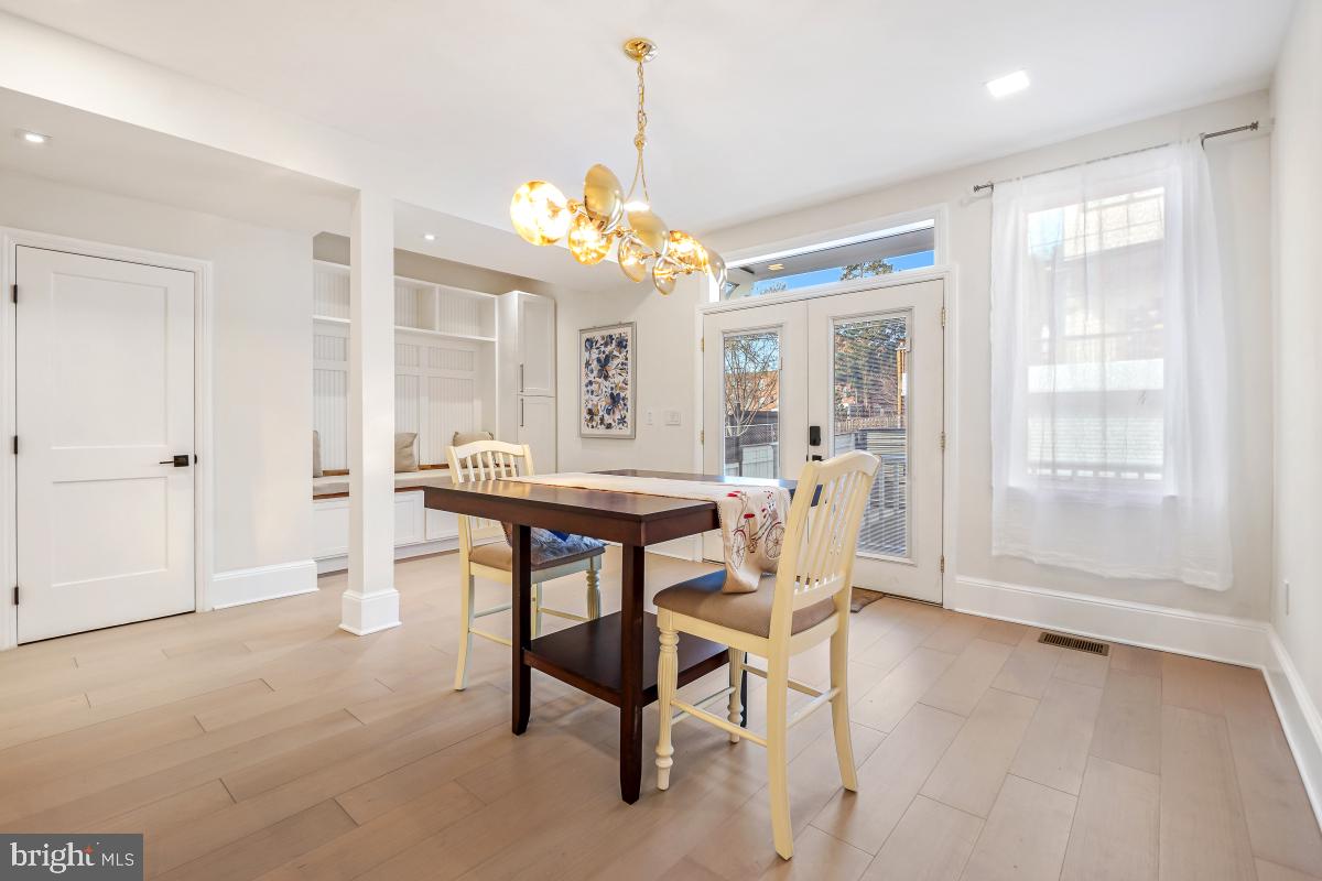 4420 15th Street Northwest Washington, DC 20011 - Photo 10 of 30 a dining room with furniture a chandelier and wooden floor