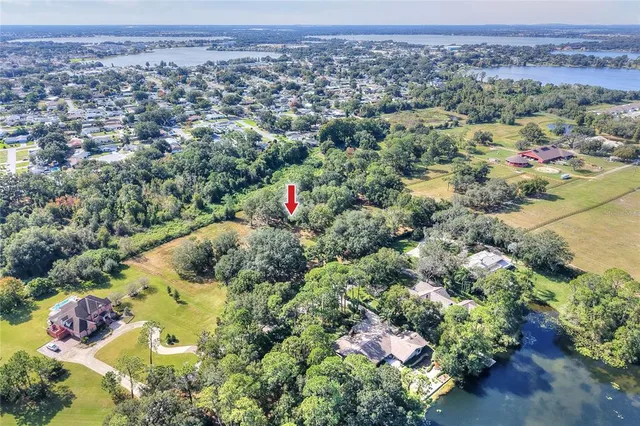 an aerial view of house with yard and mountain view in back