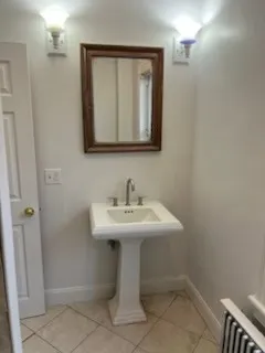 a bathroom with a sink a toilet and mirror